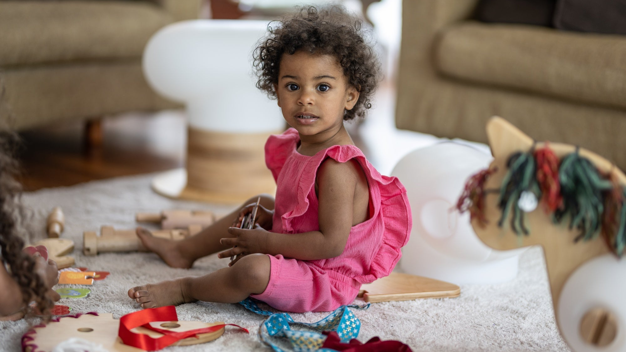 Little girl looking at the camera and half smiling